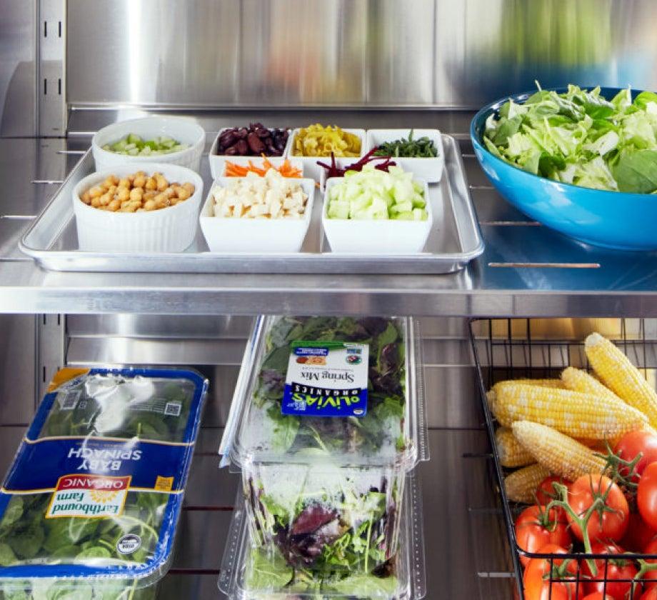 Interior of the Qoldfusion Cold Pantry refrigerator with fresh vegetables and fruits.