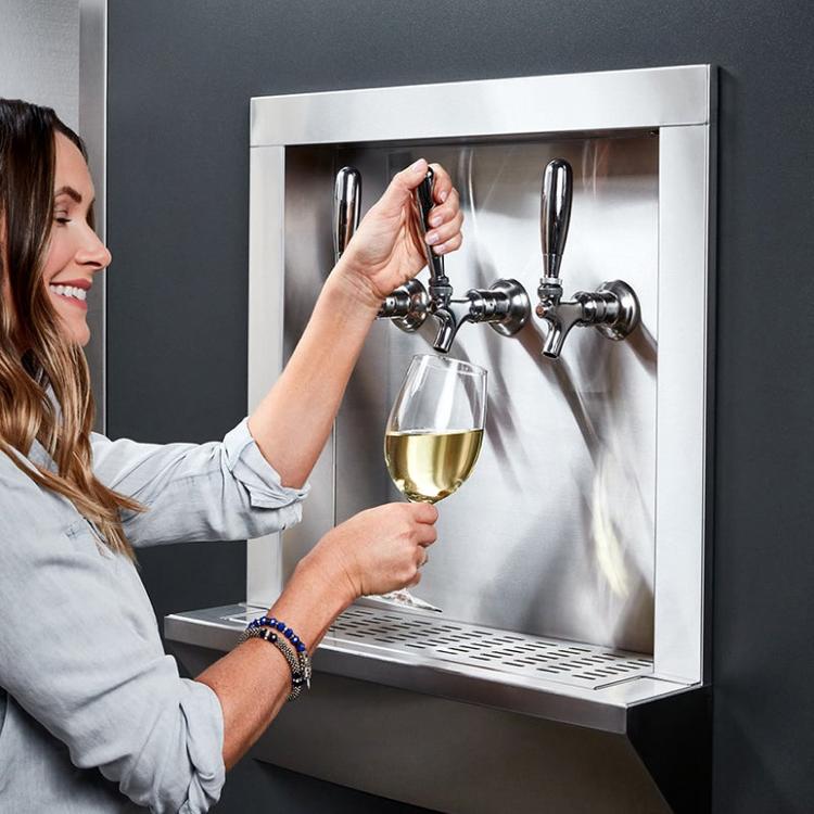 Beverage dispensing taps on the side of a Qoldfusion refrigerator.