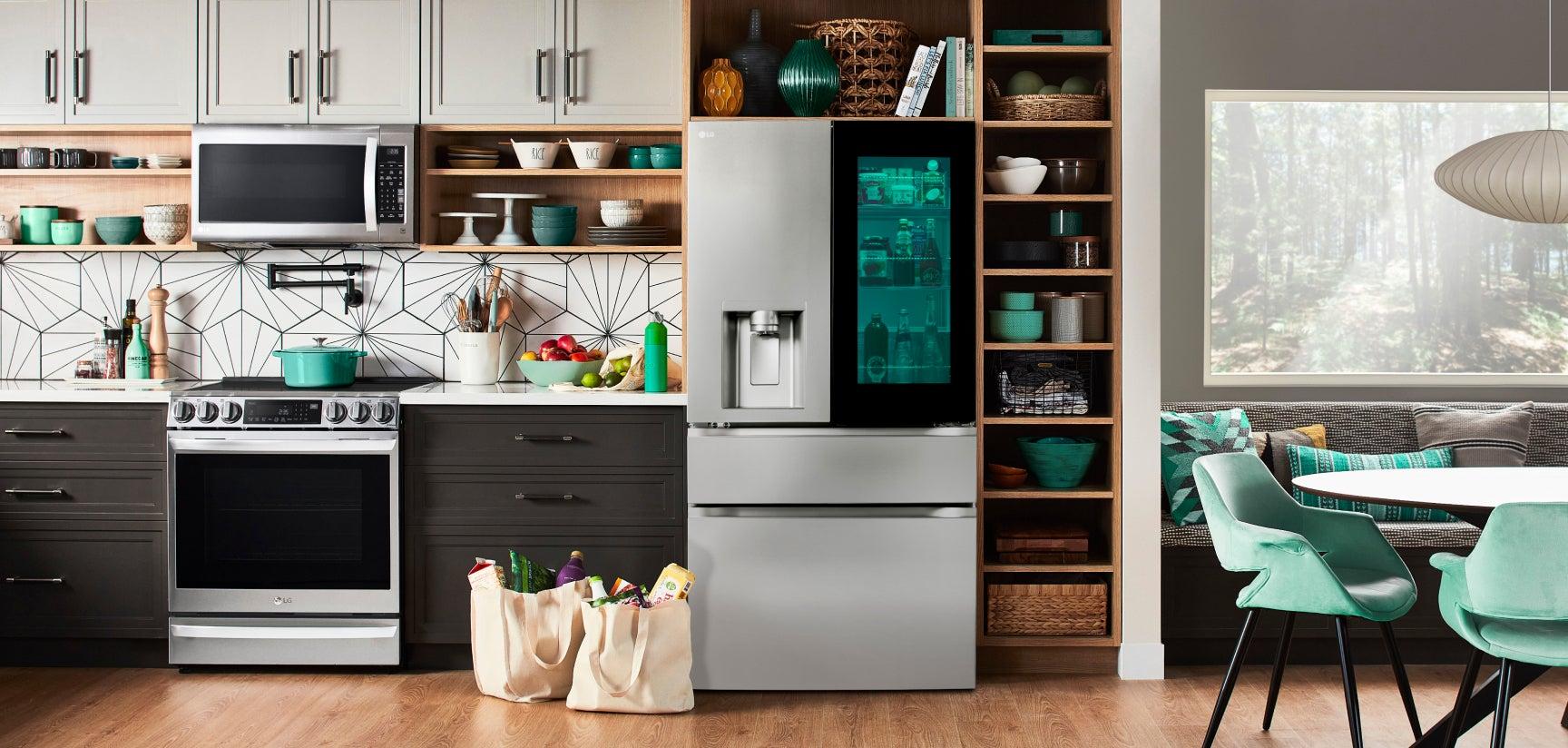 Contemporary kitchen with LG appliances, including a sleek oven, microwave, and refrigerator with glass door, featuring turquoise accents.