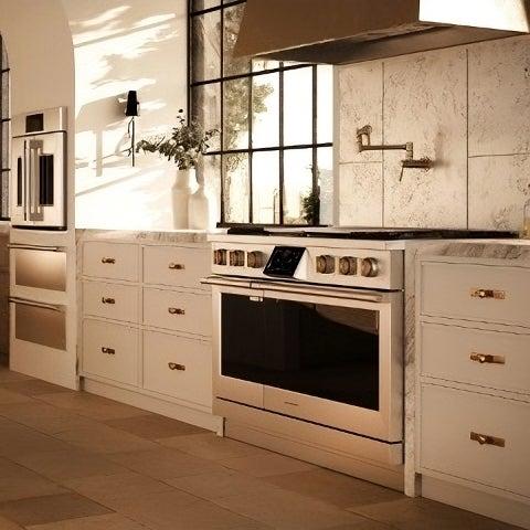 Modern kitchen with black and white cabinetry and industrial style appliances, including a sleek stovetop.